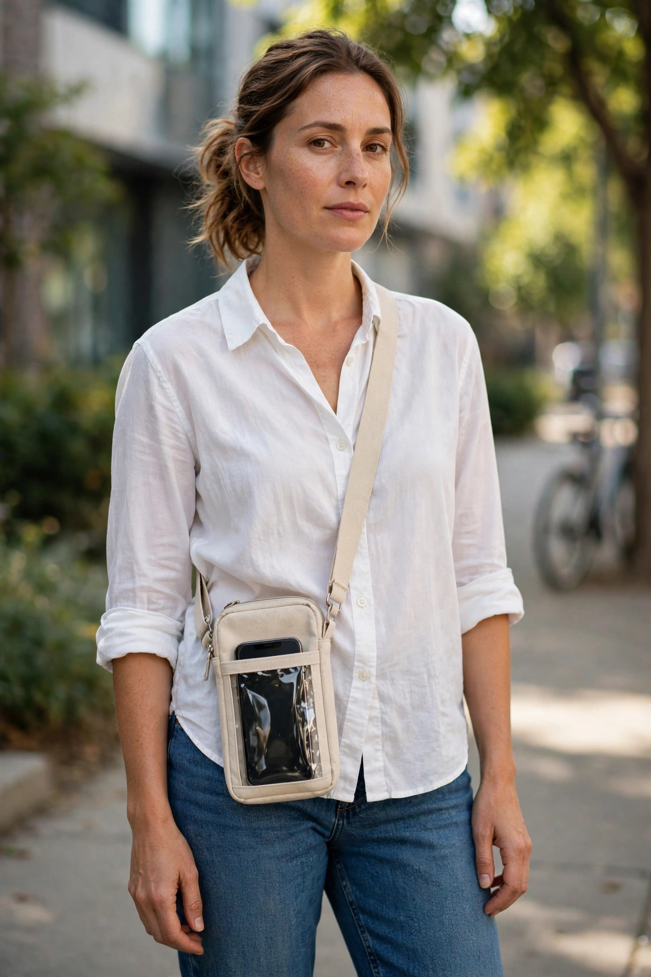 Crossbody phone bag paired with jeans and a white shirt for a hands-free everyday outfit