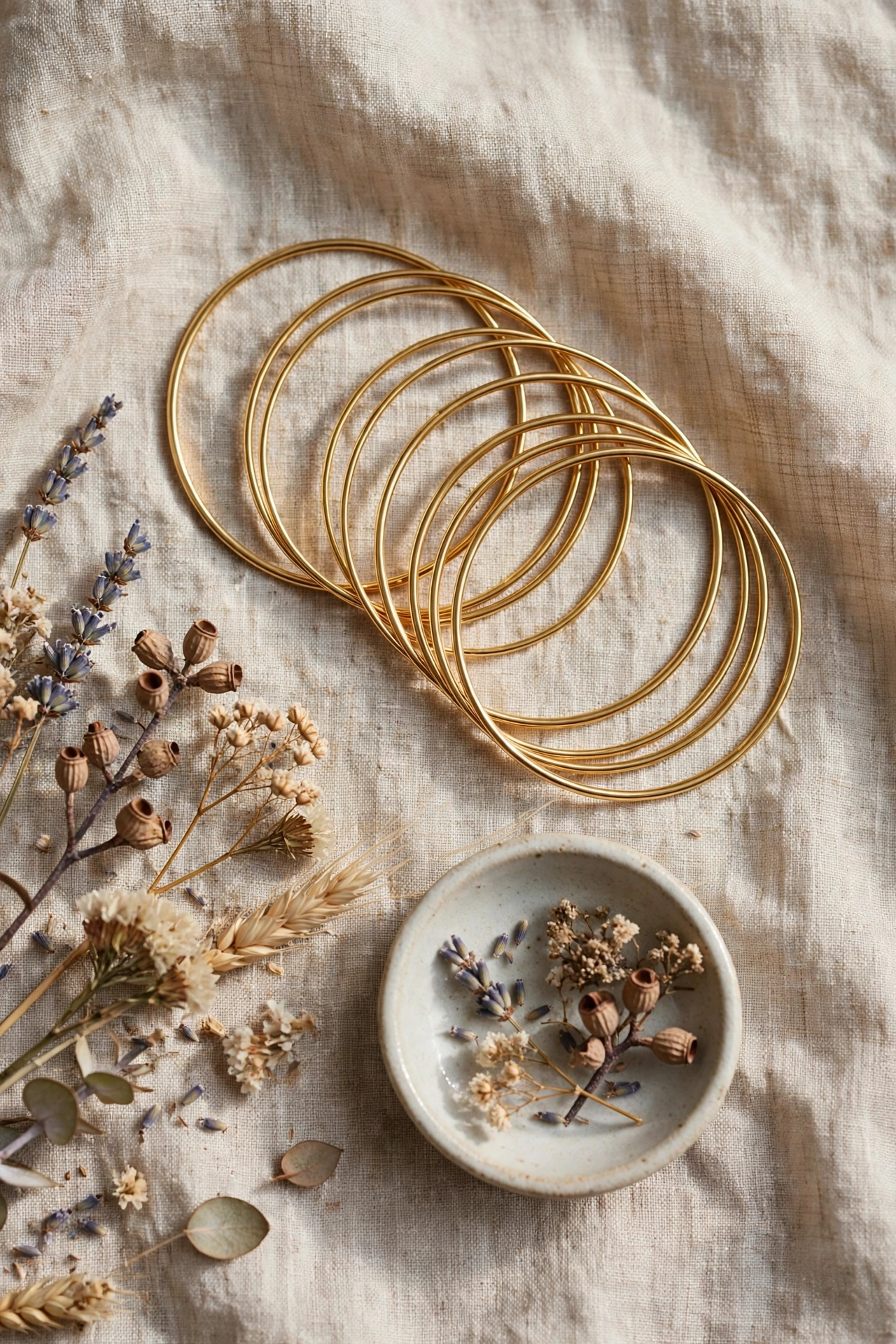 Flat lay of layered gold bangles arranged for stacking