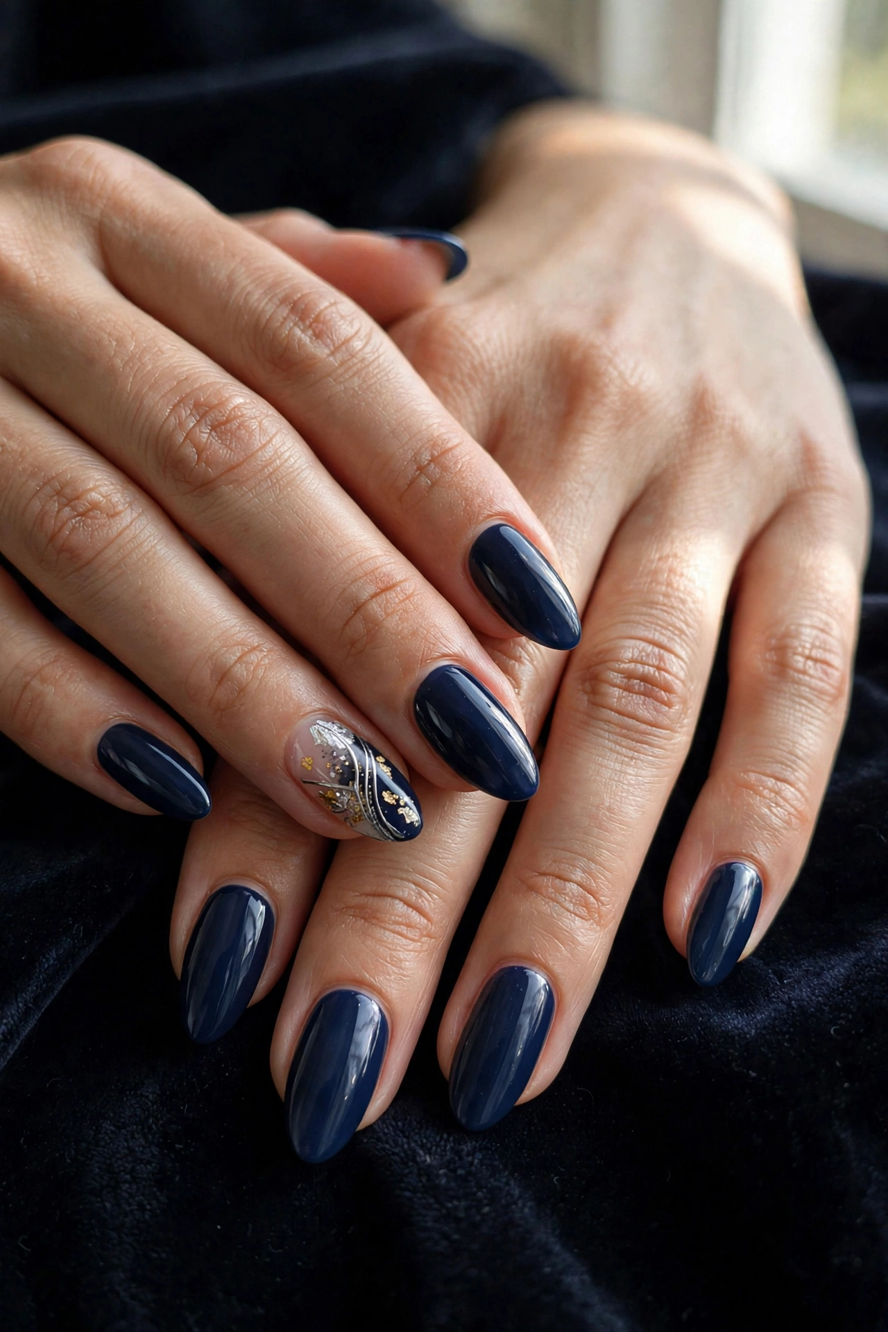 Navy almond nails with silver and gold accent detail